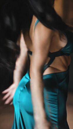 Brunette in Teal Evening Gown Teases with Open Back and Cleavage