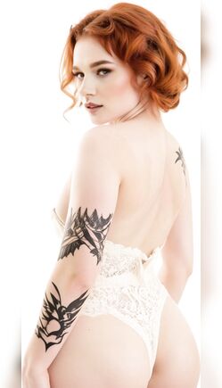 Redhead in White Lace Lingerie Showing Back Tattoos