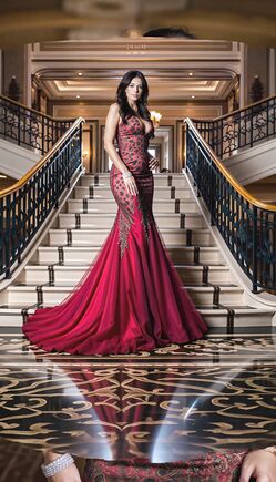 Elegant Brunette Woman in Red Dress on Grand Staircase