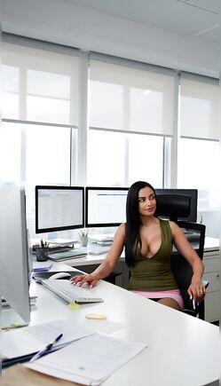 Seductive Office Secretary Teasing at Modern Desk